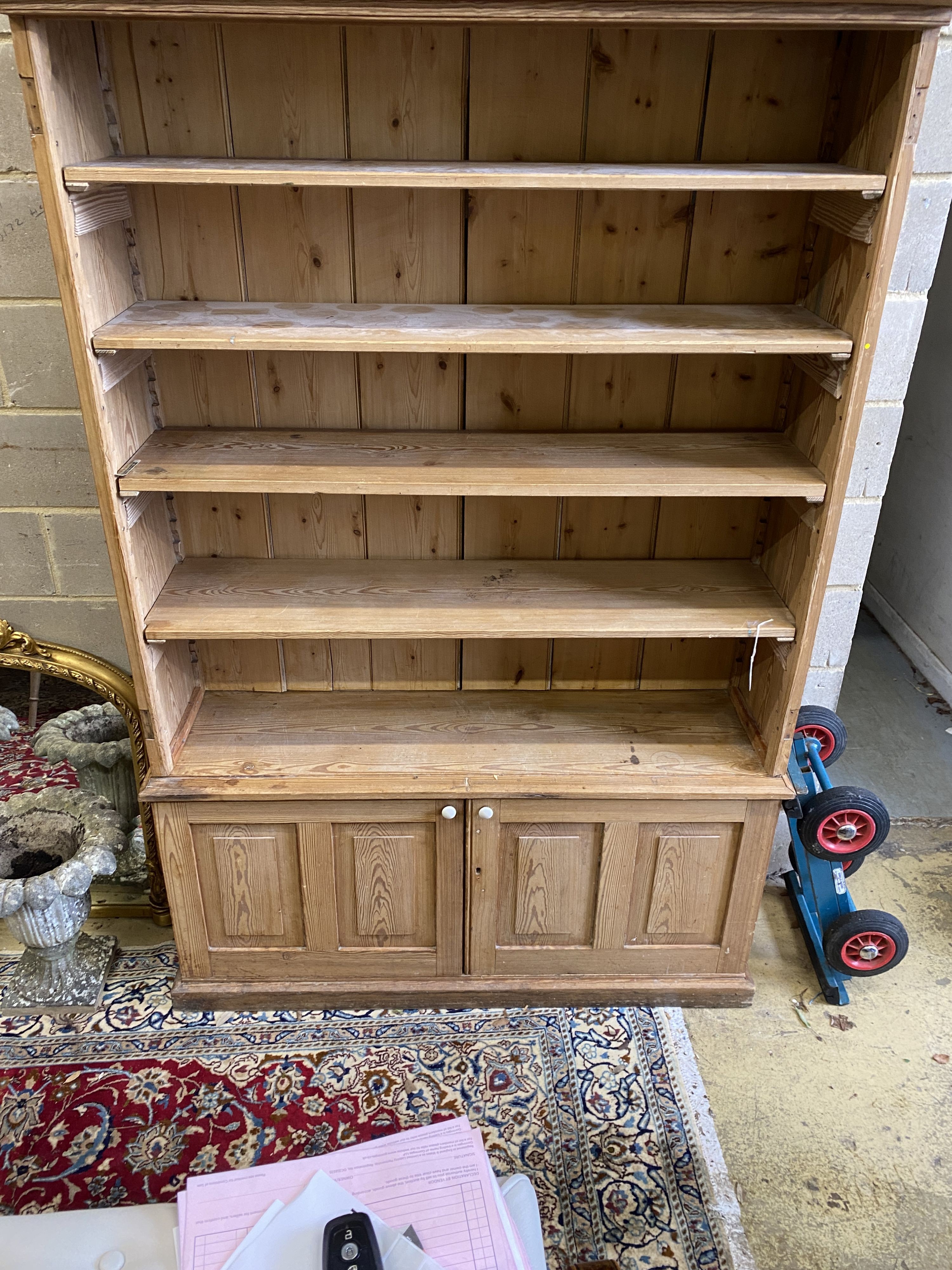 A Victorian stripped pine open fronted bookcase cupboard, length 150cm, depth 42cm, height 214cm